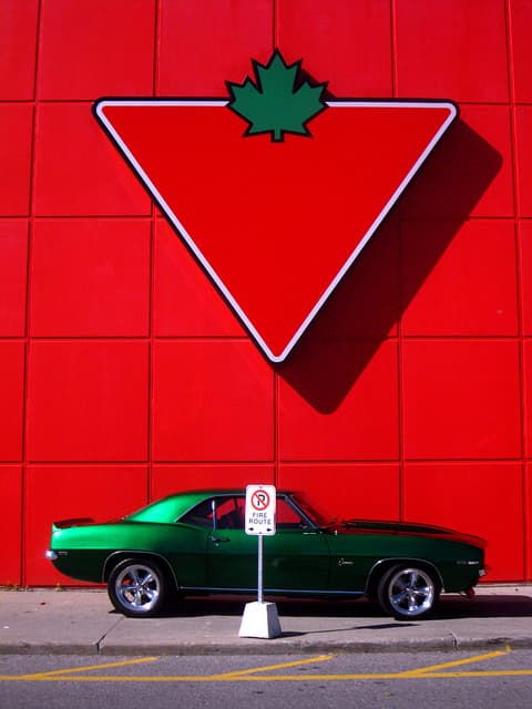 Red & Green: A 1969 Chevy Camaro under a giant Canadian Tire logo.