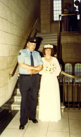 Rose Simpson poses with a security guard at her wedding on Parliament Hill.