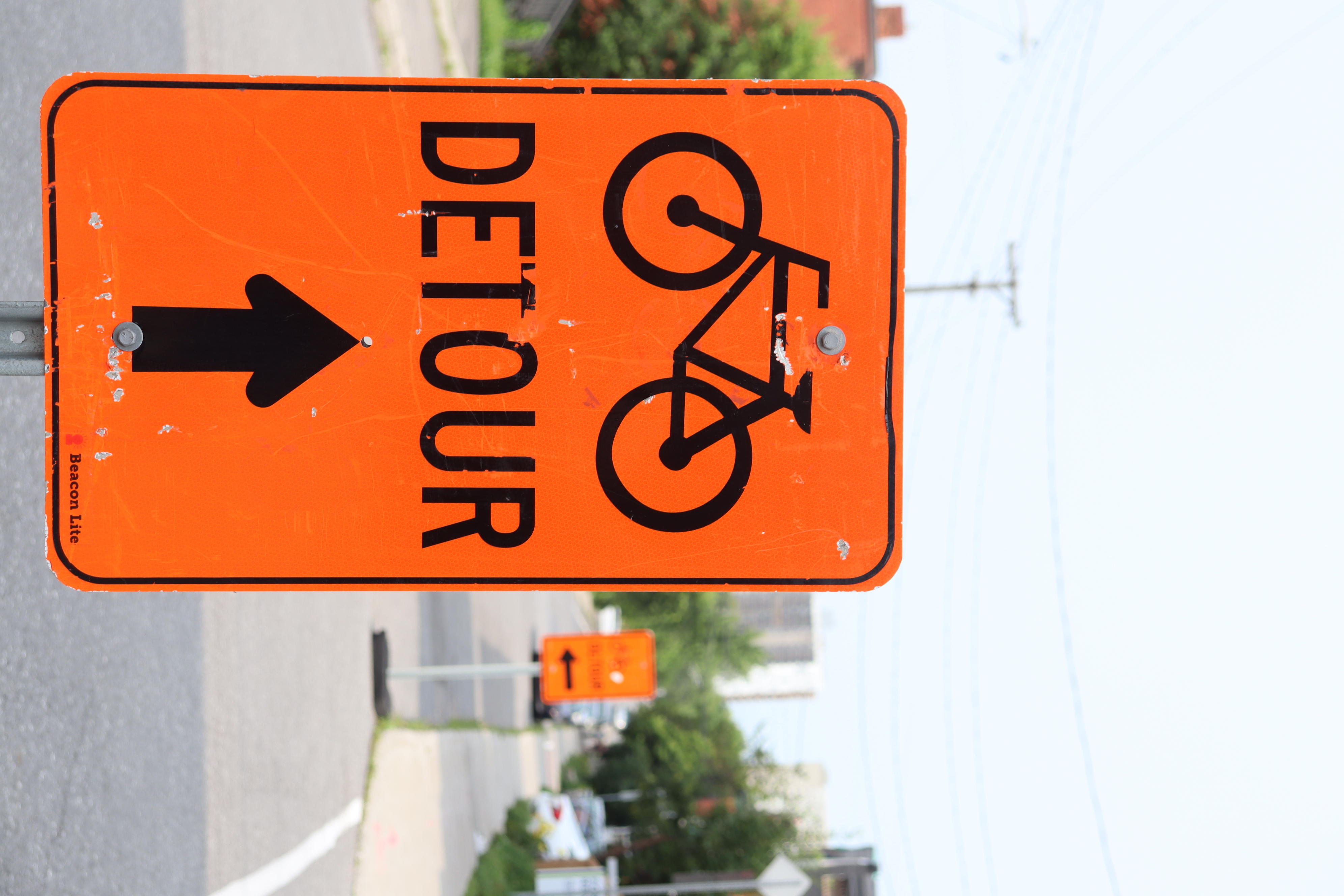 A detour sign indicates the route for cyclists to take to get around the Bronson Avenue closure.