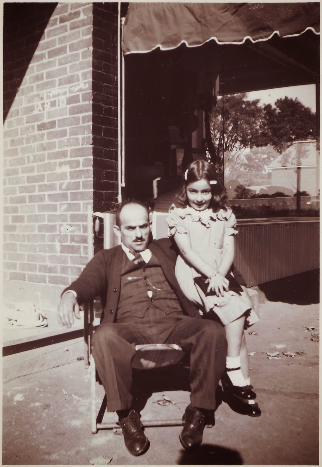 George Monsour and daughter Carolyn outside their store, mid-late 1940s.